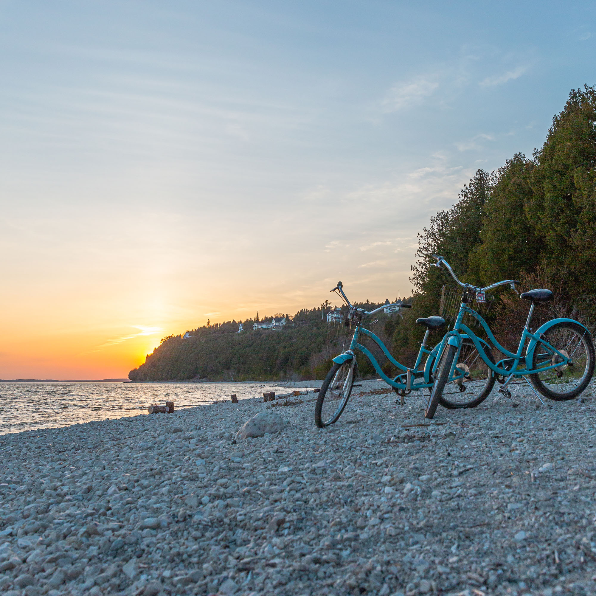 mackinac island sunset with two blue bikes on the beach